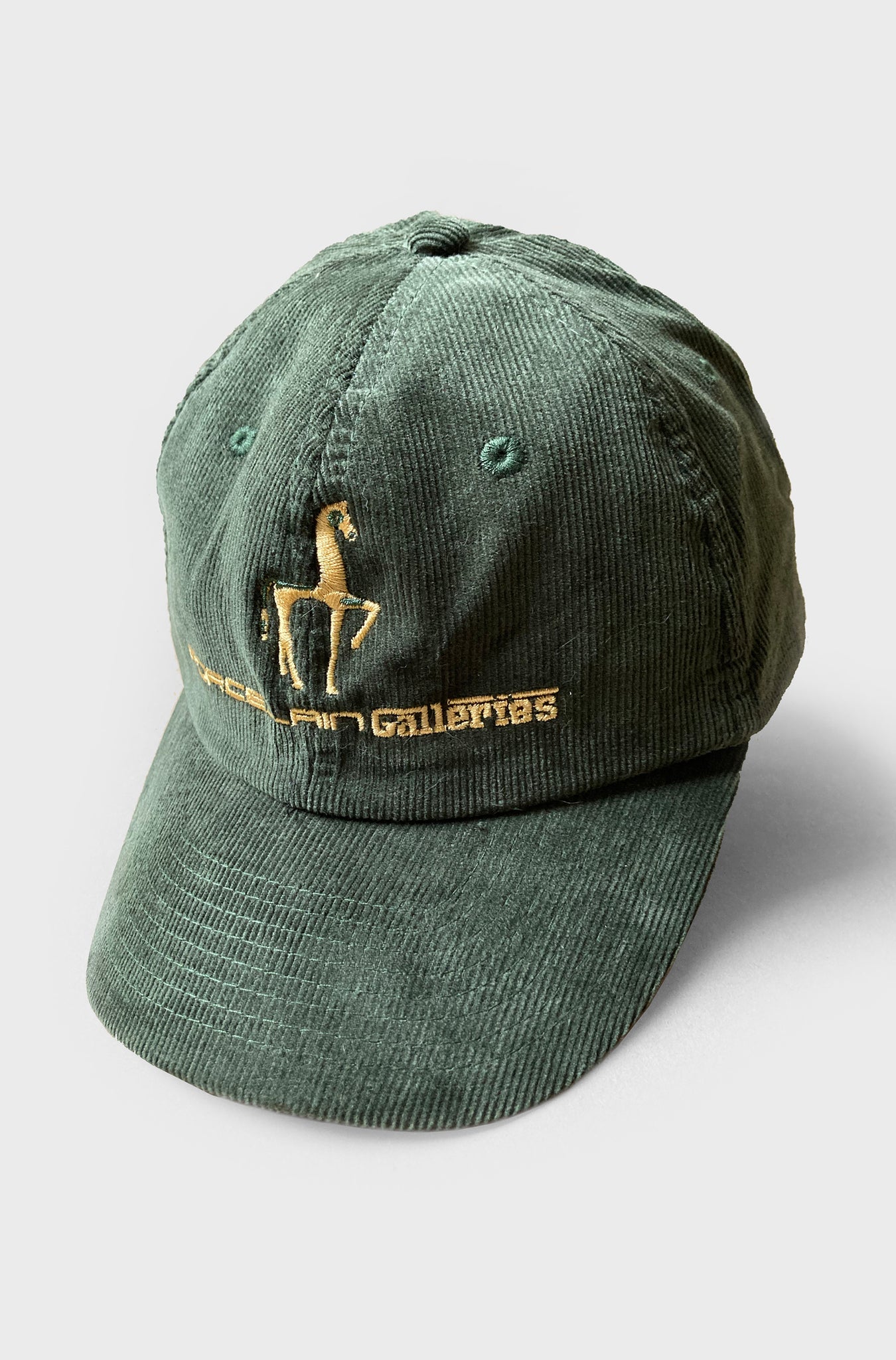 Porcelain Galleries Embroidered peaked cap. Green Corduroy